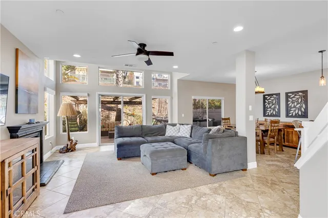 a living room with furniture and a ceiling fan