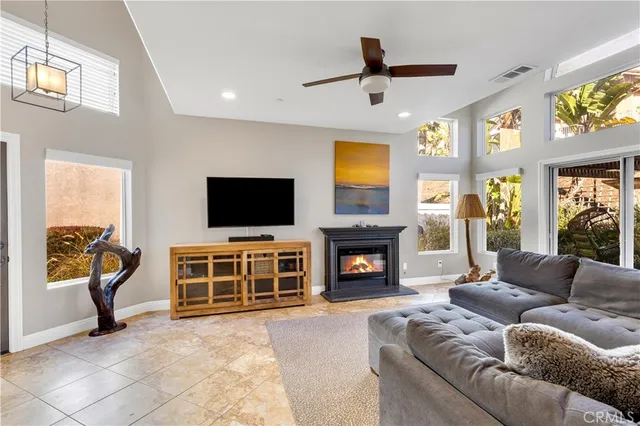 a living room with fireplace furniture and a flat screen tv