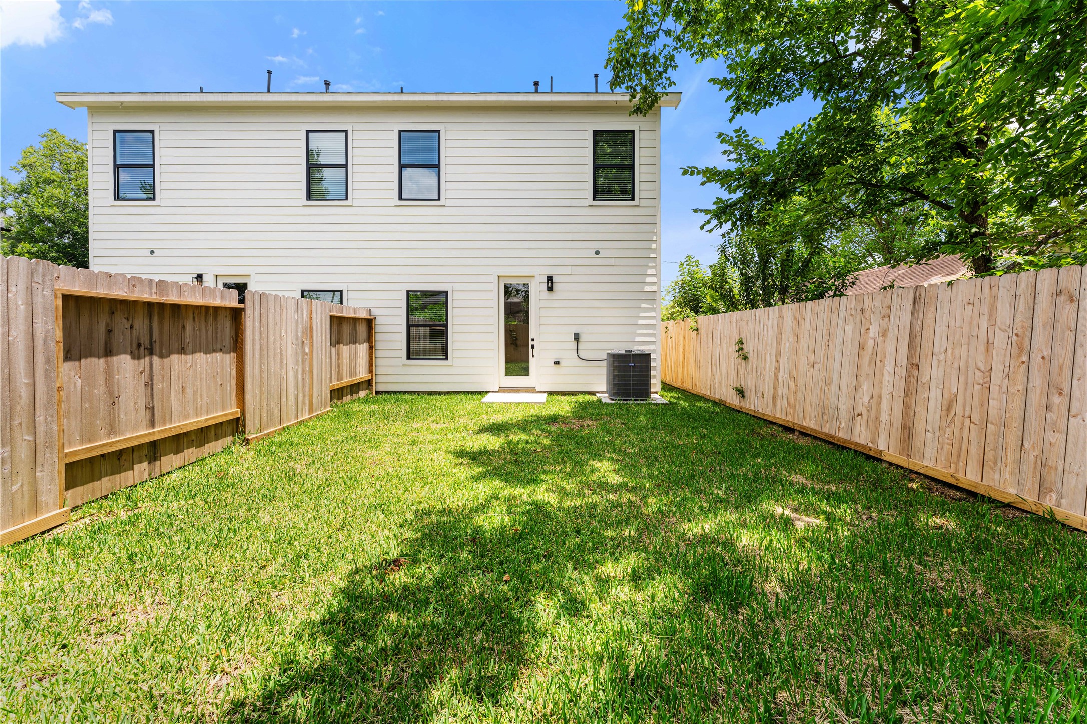 3620 Mt Pleasant Street, Unit A Houston, TX 77021 - Photo 22 of 23 a view of a backyard with large trees and wooden fence