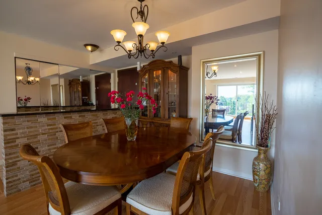 a view of a dining room with furniture and chandelier