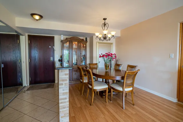 a view of a dining room with furniture and chandelier