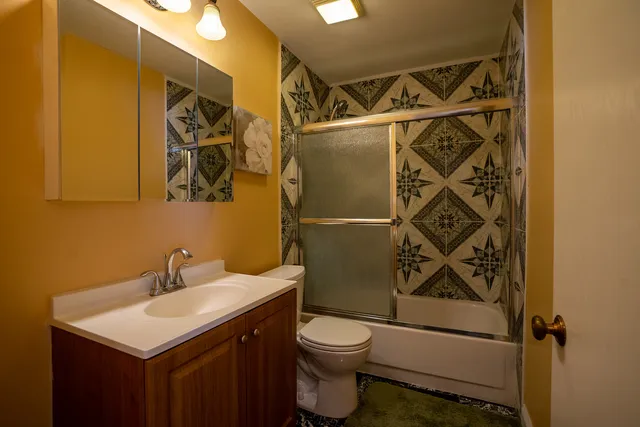 a bathroom with a sink toilet and shower