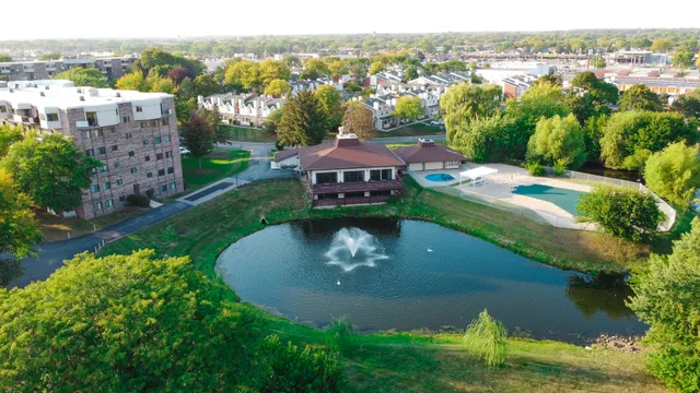 an aerial view of a house with a yard and lake view