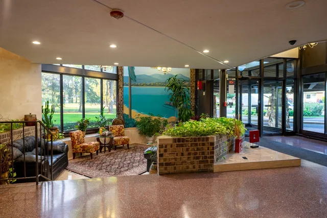 a living room with furniture and garden view