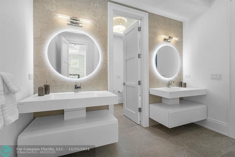 1122 Miramar Drive Delray Beach, FL 33483 - Photo 29 of 44 a en suite bathroom with a double vanity sink and a mirror