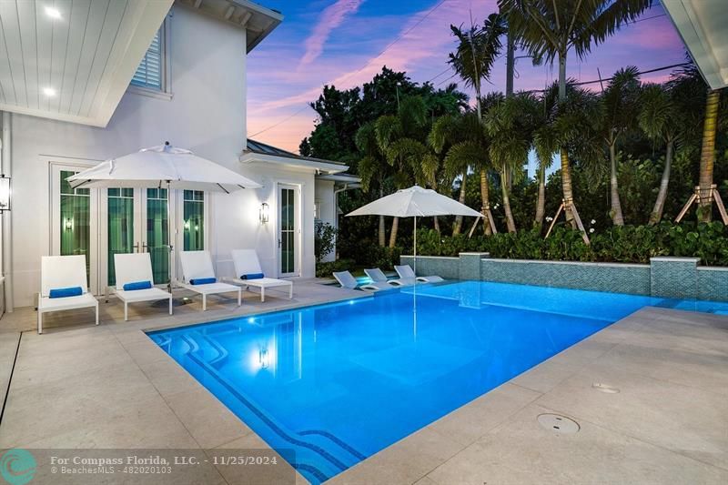 1122 Miramar Drive Delray Beach, FL 33483 - Photo 38 of 44 a view of pool with table and chairs under an umbrella