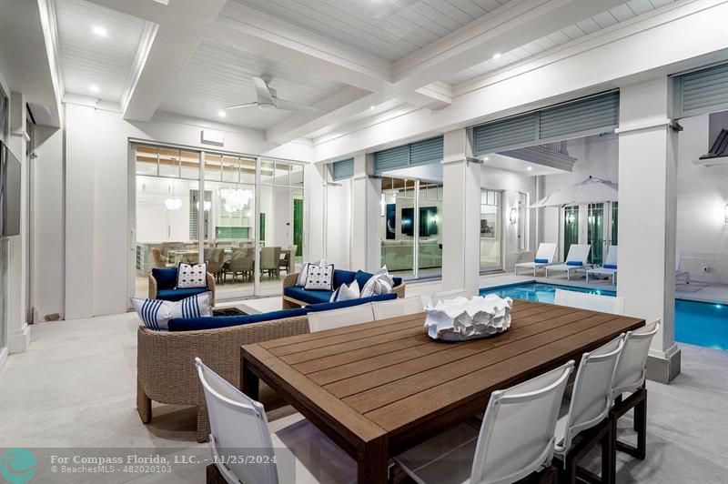 1122 Miramar Drive Delray Beach, FL 33483 - Photo 40 of 44 a dining room with furniture a large window and potted plants
