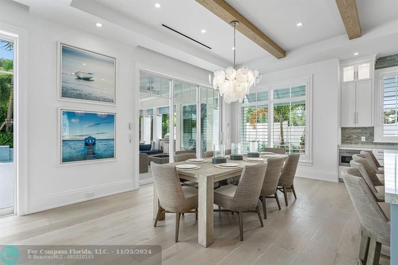 1122 Miramar Drive Delray Beach, FL 33483 - Photo 10 of 44 a view of a dining room with furniture wooden floor and chandelier