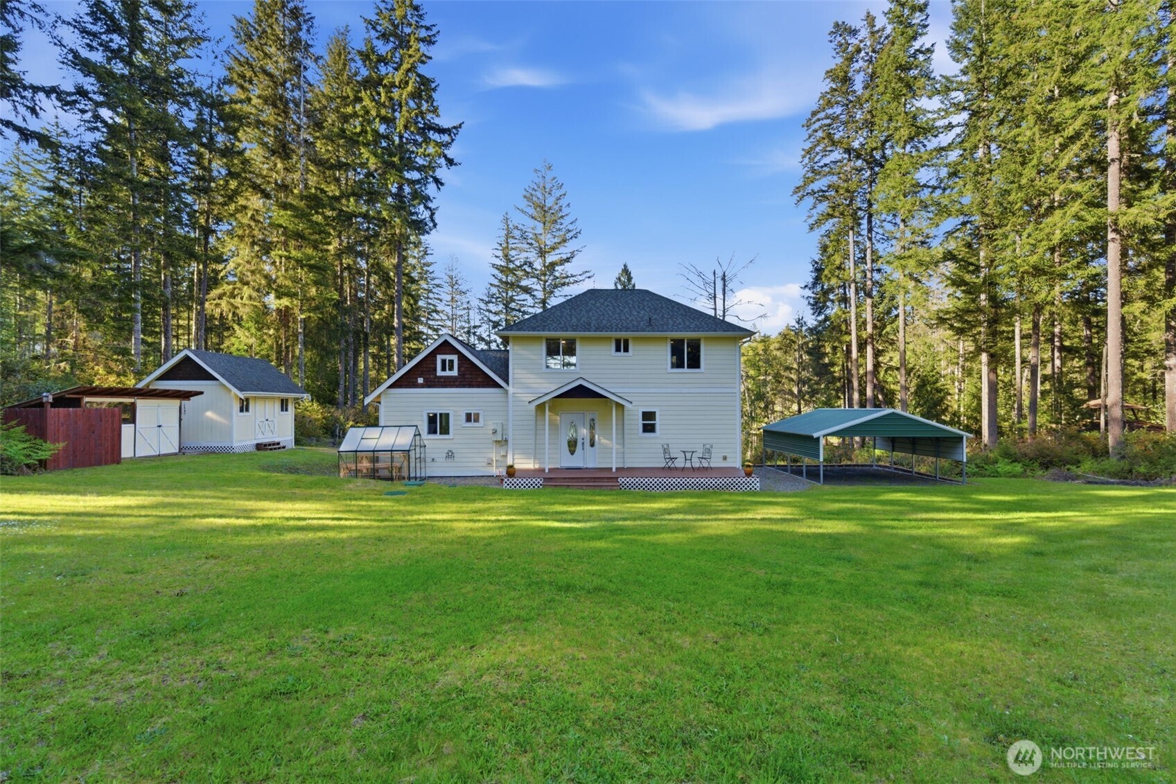 6971 Northeast Tahuya Blacksmith Road Belfair, WA 98528 - Photo 37 of 38 a front view of a house with a yard