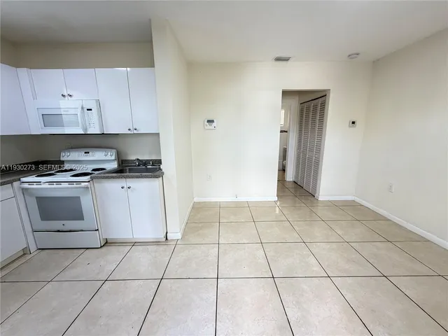 a kitchen with a stove a sink and a refrigerator
