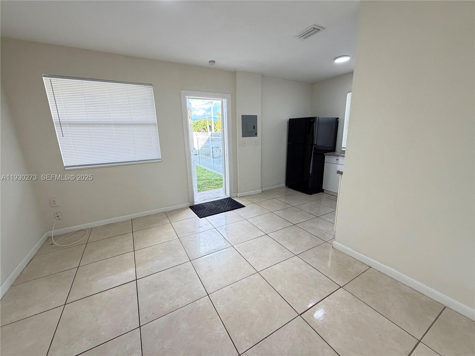 609 Northwest 7th Avenue, Unit 12 Hallandale Beach, FL 33009 - Photo 14 of 18 a view of an empty room with window and cabinet