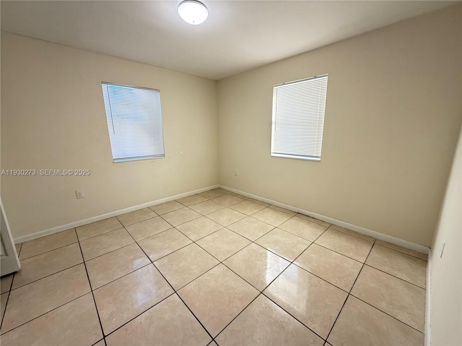 609 Northwest 7th Avenue, Unit 12 Hallandale Beach, FL 33009 - Photo 15 of 18 a view of an empty room and a window