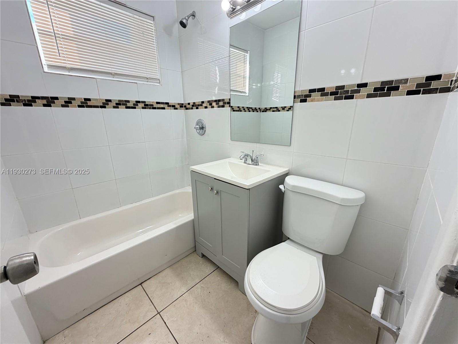 609 Northwest 7th Avenue, Unit 12 Hallandale Beach, FL 33009 - Photo 16 of 18 a bathroom with a toilet a sink and bathtub