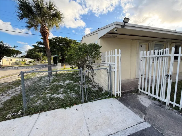 a view of a house with a tree in the yard