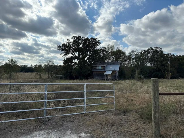 a view of a house with a backyard and chair