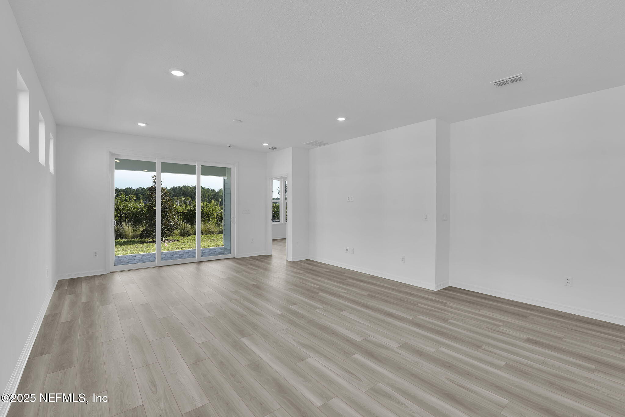 269 Ecliptic Loop Yulee, FL 32097 - Photo 11 of 44 wooden floor in an empty room with a window