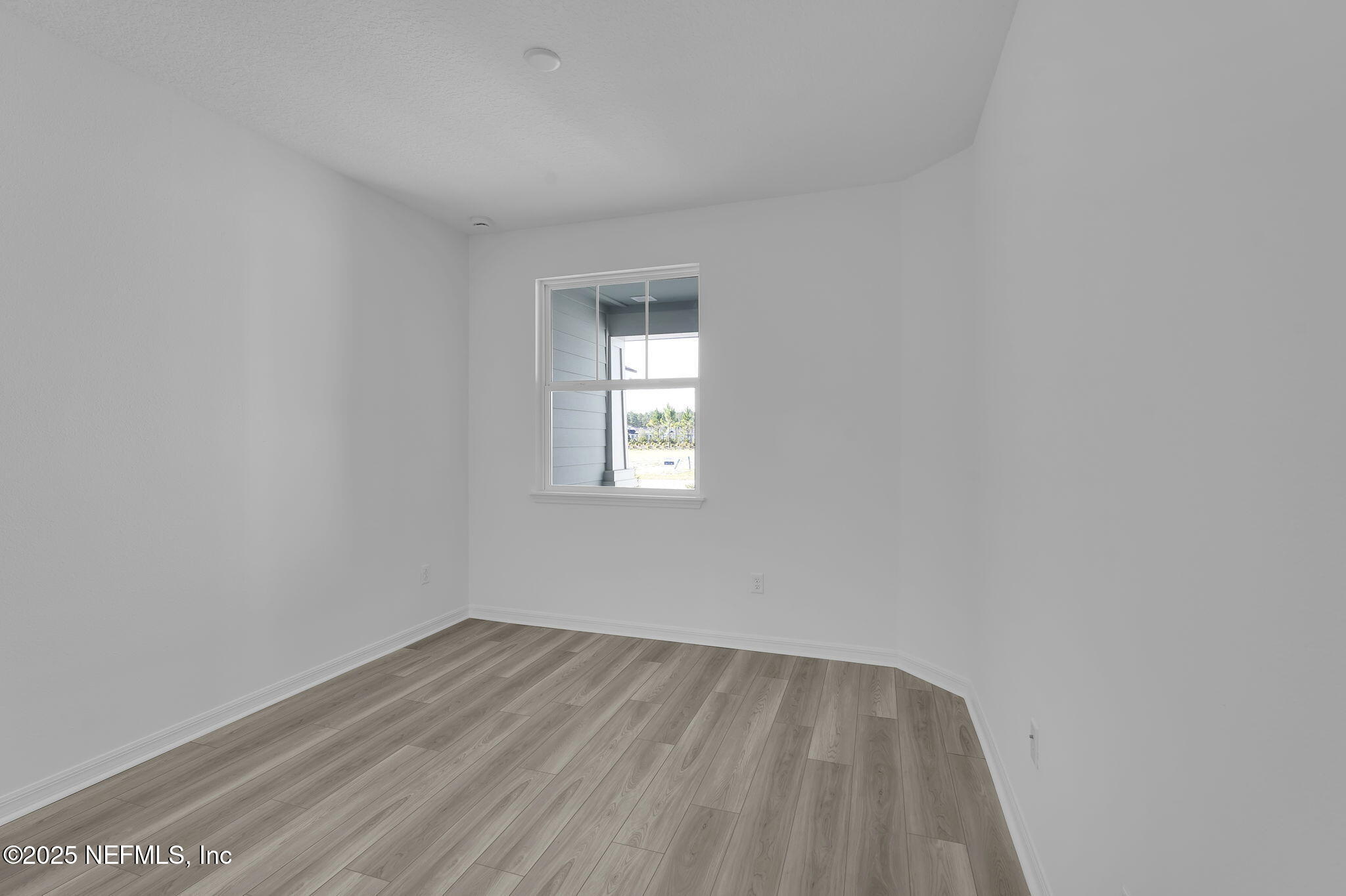 269 Ecliptic Loop Yulee, FL 32097 - Photo 20 of 44 a view of empty room with wooden floor