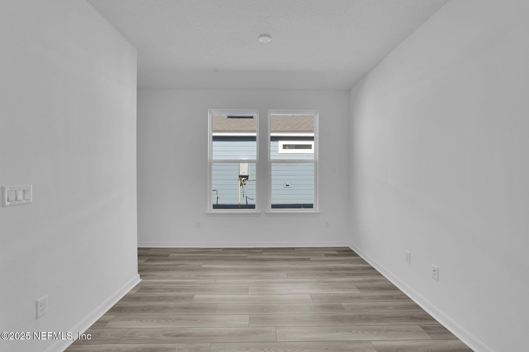 269 Ecliptic Loop Yulee, FL 32097 - Photo 21 of 44 a view of empty room with window and wooden floor