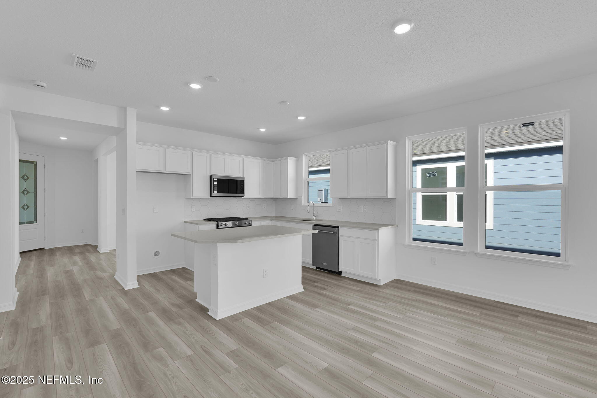 269 Ecliptic Loop Yulee, FL 32097 - Photo 5 of 44 a large kitchen with stainless steel appliances granite countertop a stove and a sink