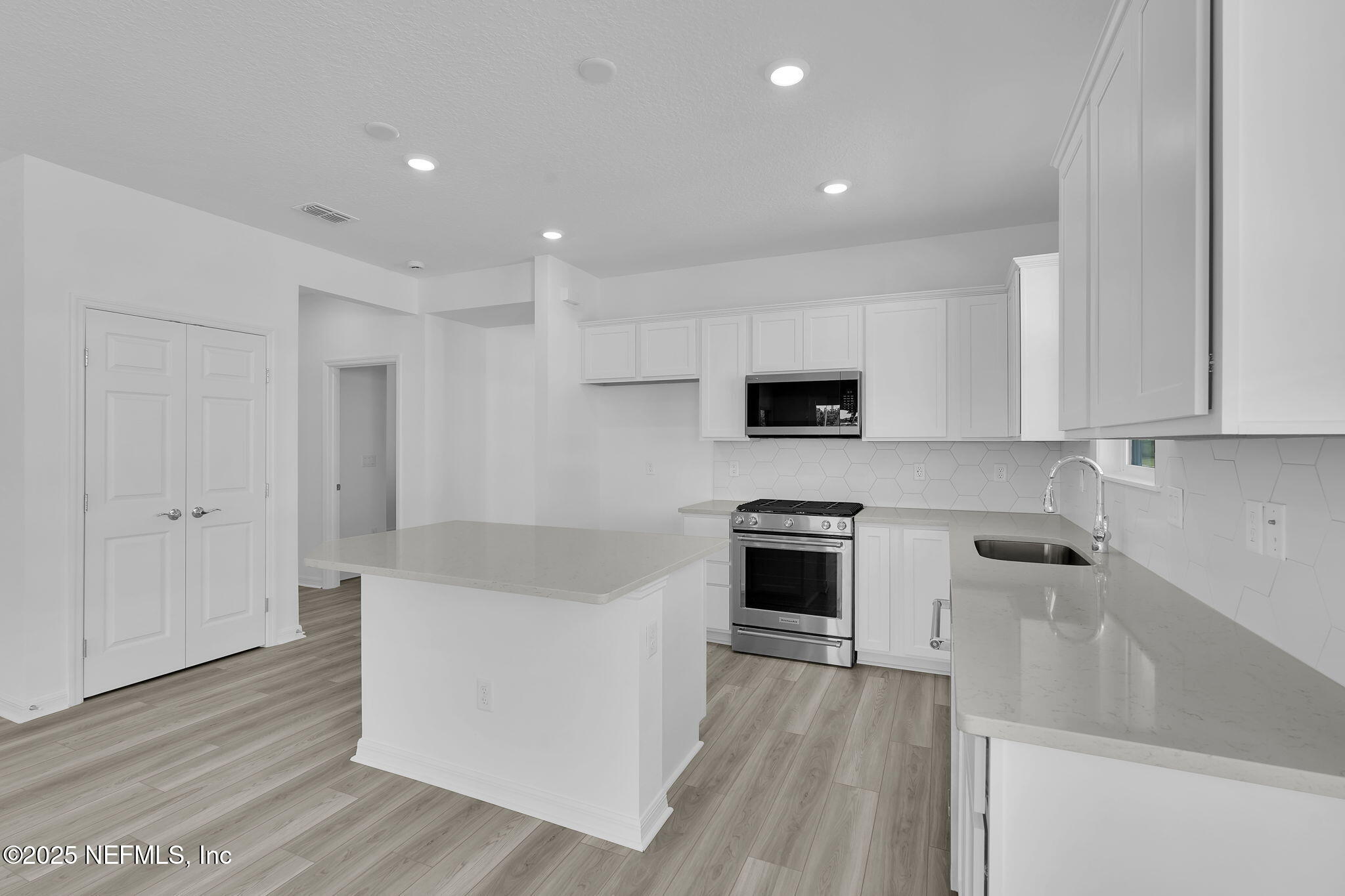 269 Ecliptic Loop Yulee, FL 32097 - Photo 8 of 44 a kitchen with stainless steel appliances granite countertop a stove a sink and a refrigerator