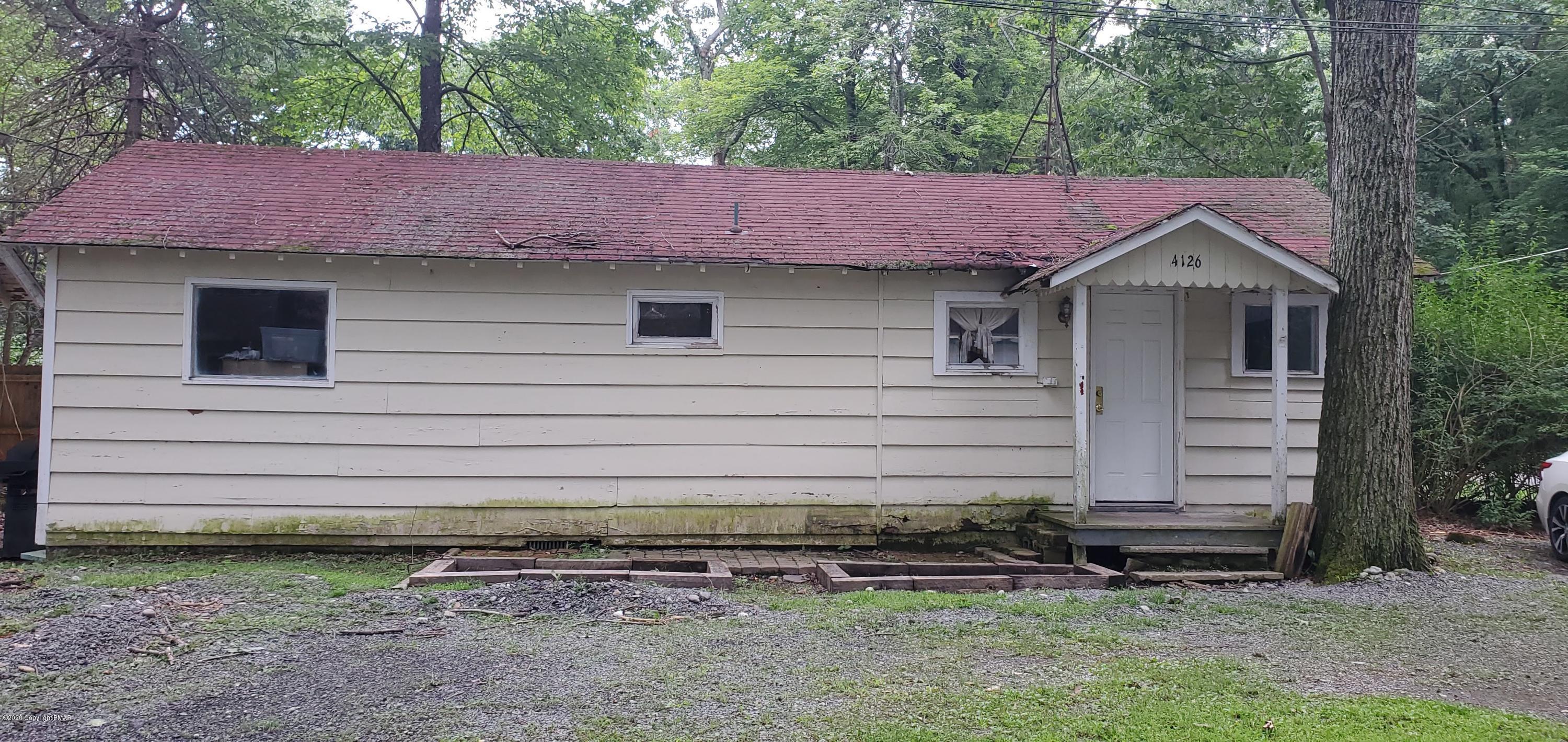 4132 Norton Pryor Road Pocono Summit, PA 18346 - Photo 13 of 36 a view of a house with a yard and tree