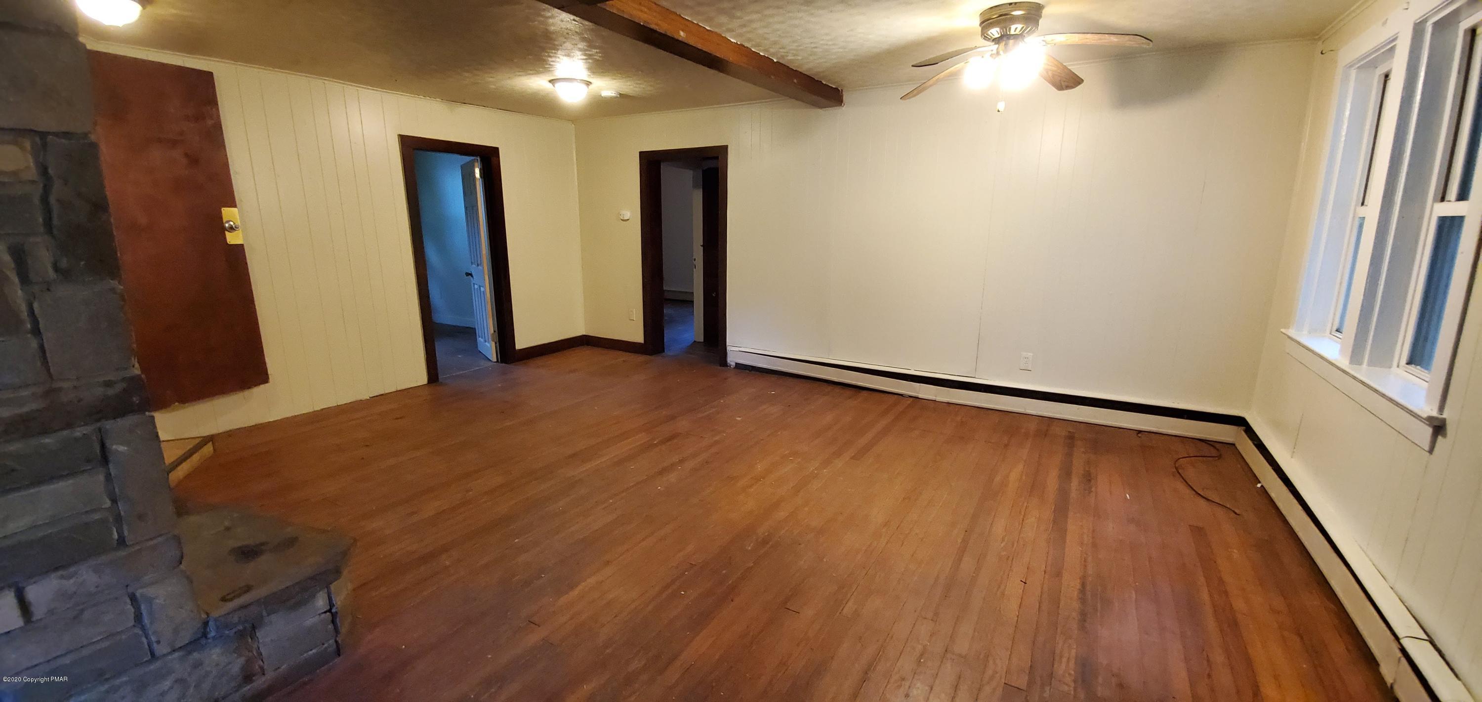 4132 Norton Pryor Road Pocono Summit, PA 18346 - Photo 24 of 36 a view of an empty room with wooden floor and a window