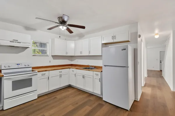 a kitchen with cabinets a refrigerator and a sink