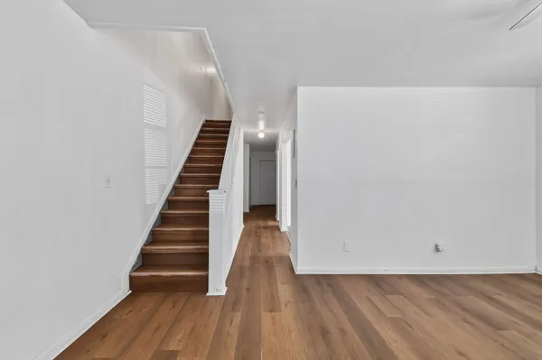 a view of a hallway with wooden floor