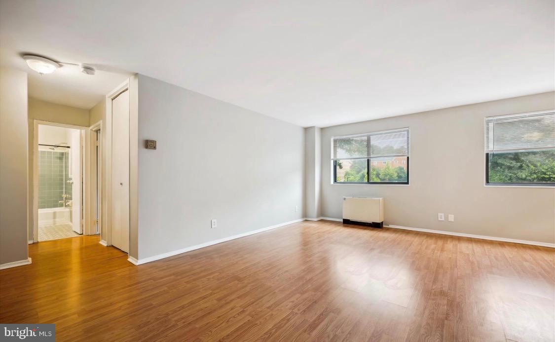 8601 Manchester Road, Unit 319 Silver Spring, MD 20901 - Photo 12 of 17 an empty room with wooden floor and windows