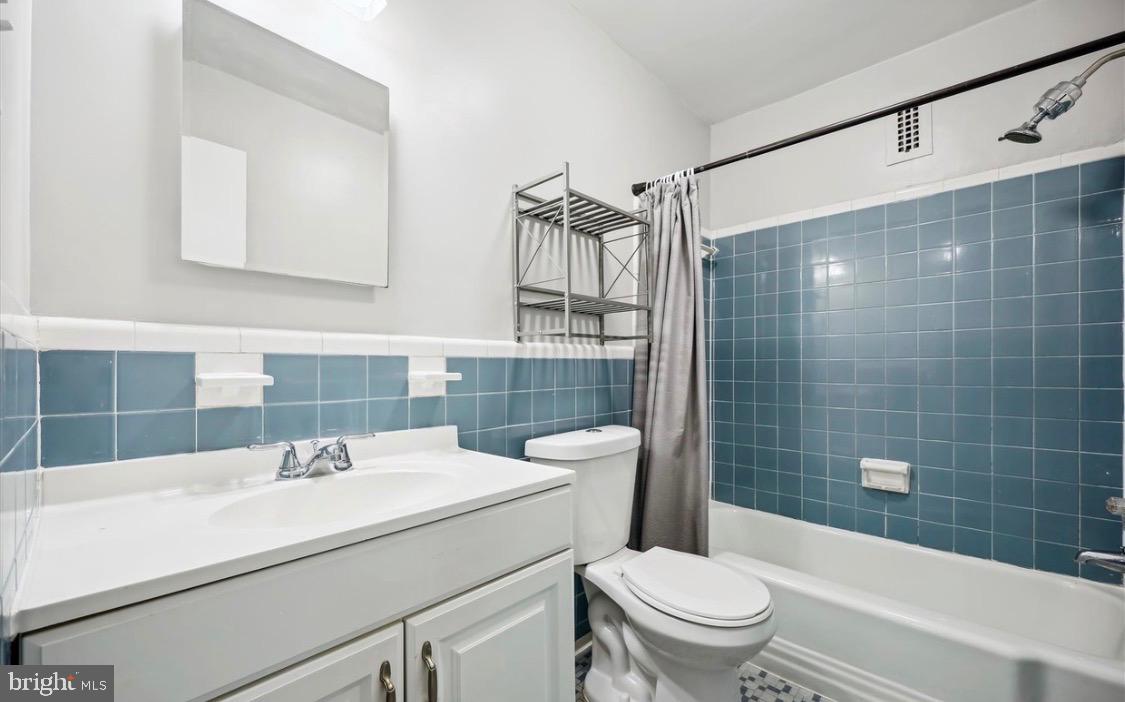 8601 Manchester Road, Unit 319 Silver Spring, MD 20901 - Photo 14 of 17 a bathroom with a sink a toilet and shower