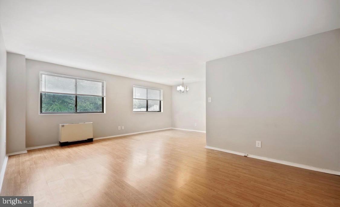 8601 Manchester Road, Unit 319 Silver Spring, MD 20901 - Photo 8 of 17 an empty room with wooden floor and windows