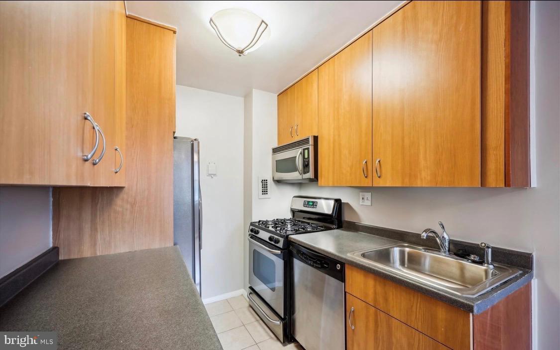 8601 Manchester Road, Unit 319 Silver Spring, MD 20901 - Photo 10 of 17 a kitchen with stainless steel appliances granite countertop a sink stove and refrigerator