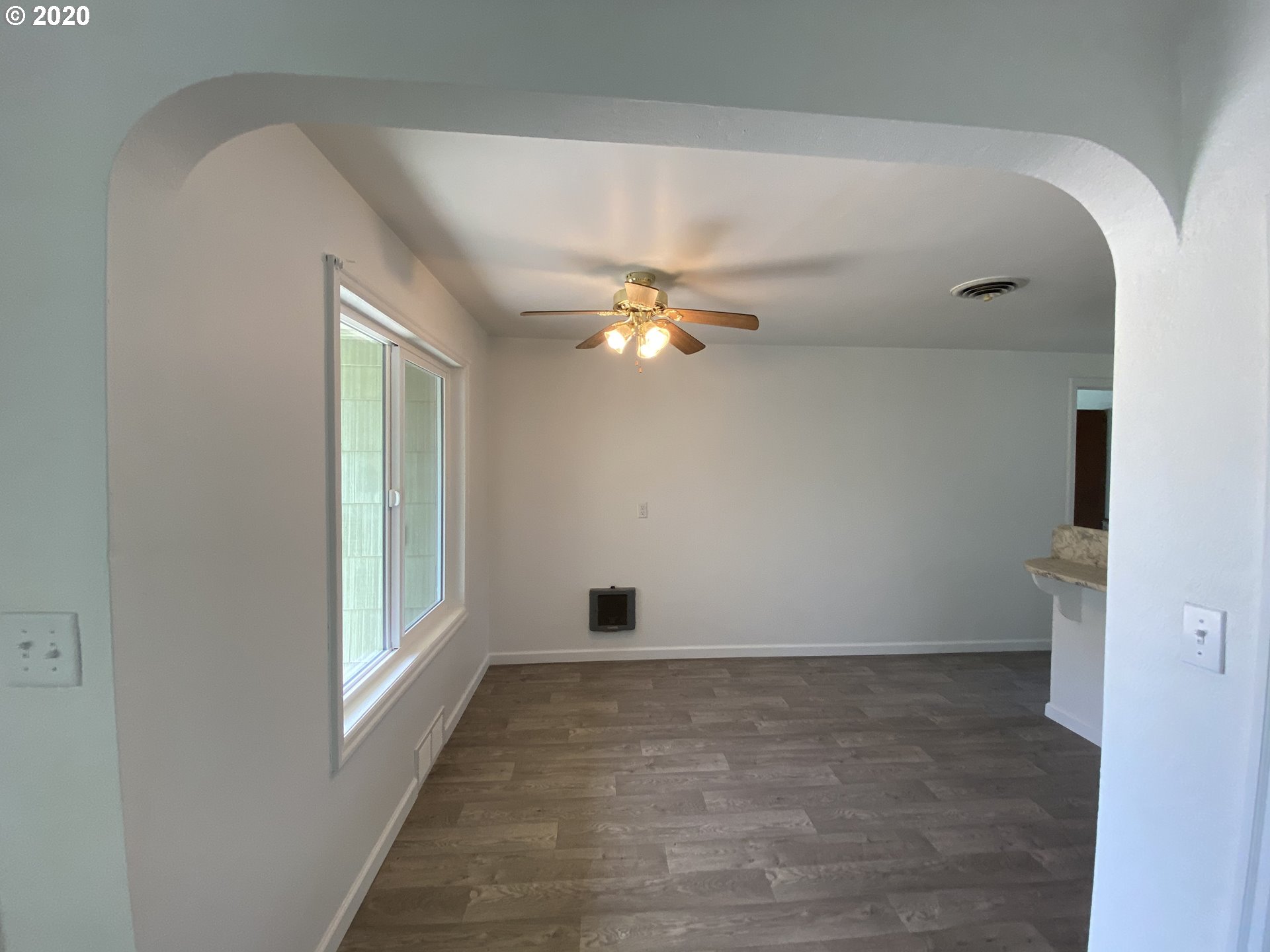 830 L Street Springfield, OR 97477 - Photo 8 of 24 a view of a livingroom with a ceiling fan and window