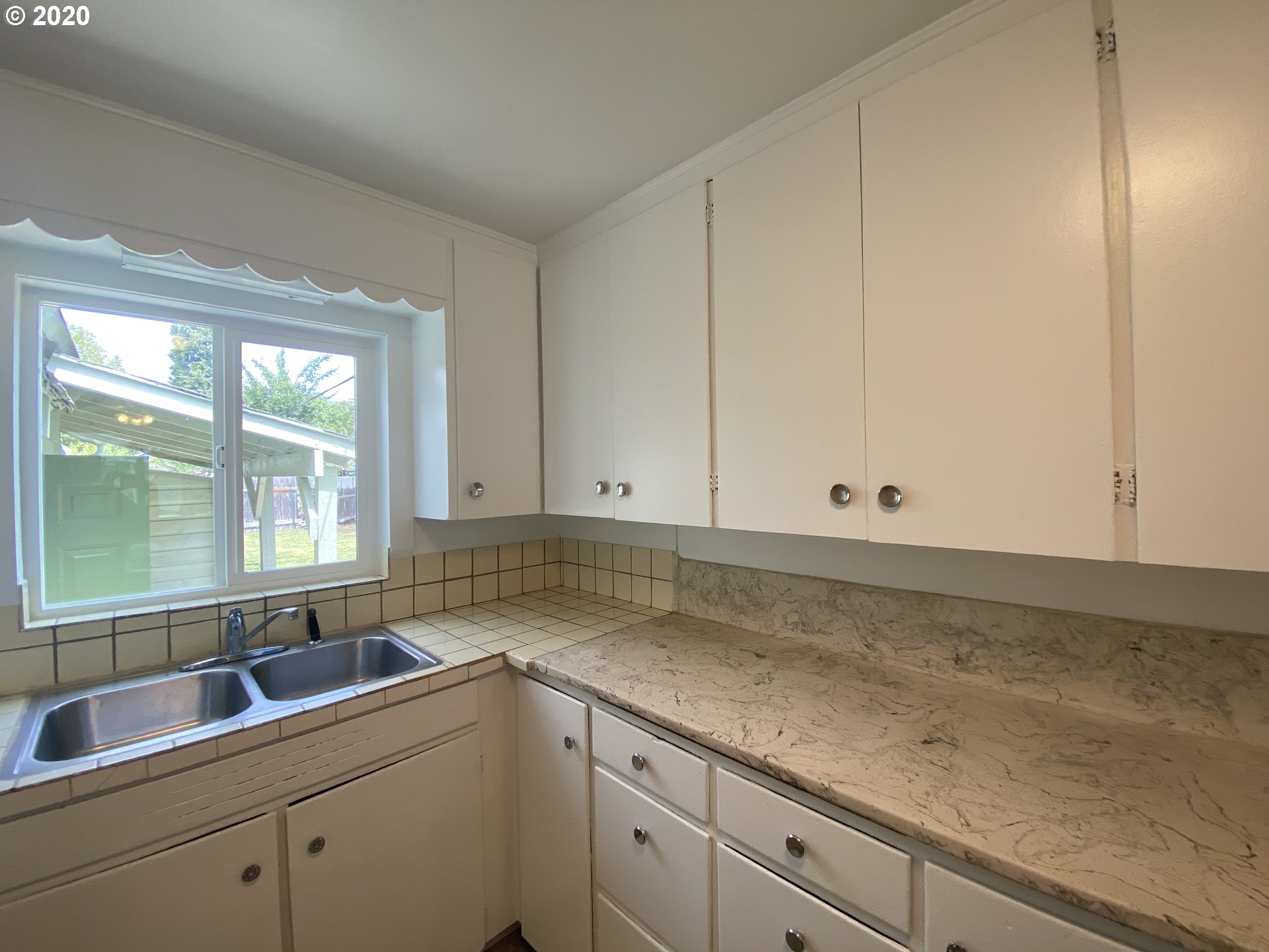 830 L Street Springfield, OR 97477 - Photo 9 of 24 a kitchen with a sink and cabinets