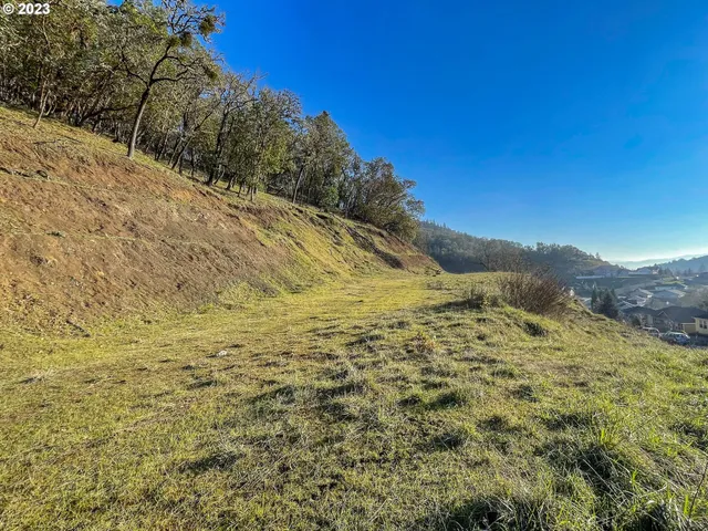 a view of a large mountain with mountains in the background
