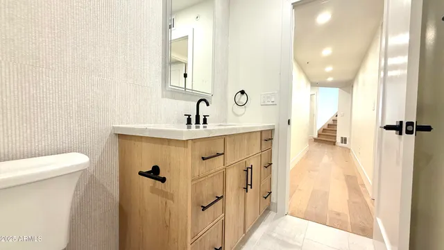 a kitchen with granite countertop a sink a stove and cabinets