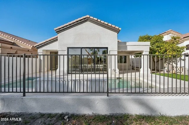 a view of a house with a backyard and a patio