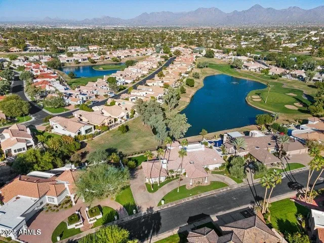 an aerial view of residential houses with outdoor space and river