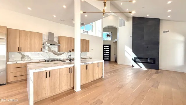 a very nice looking room with a large window and chandelier