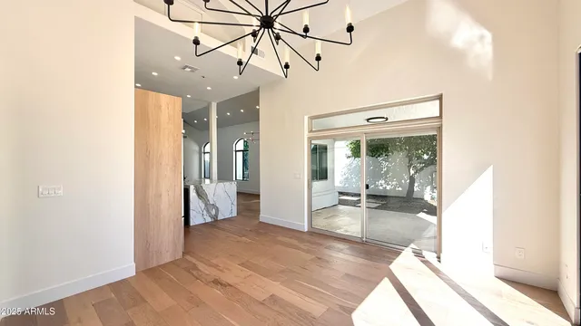 a view of a big room with wooden floor fan and windows