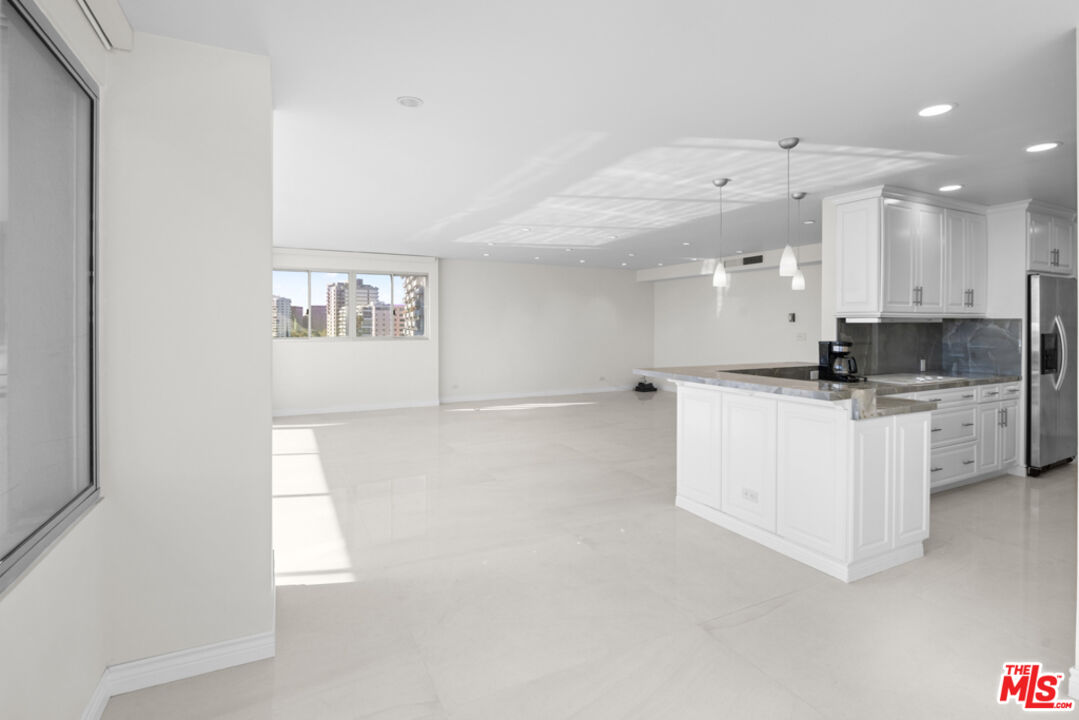 865 Comstock Avenue, Unit 10D/E Los Angeles, CA 90024 - Photo 11 of 49 a view of kitchen with center island and two windows