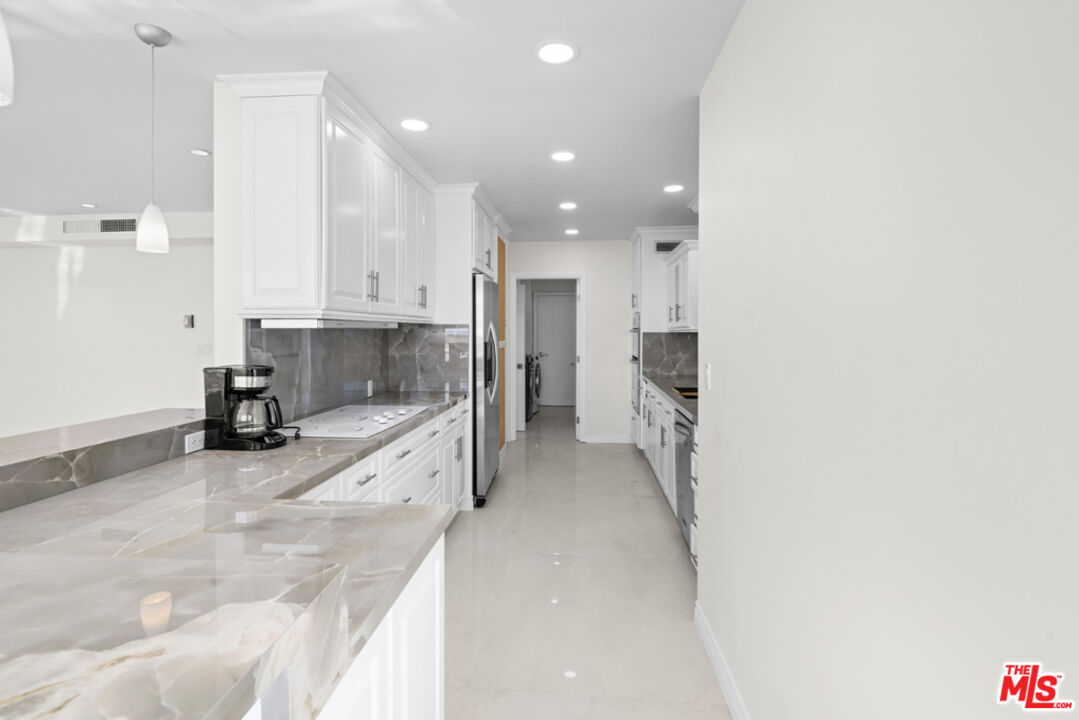 865 Comstock Avenue, Unit 10D/E Los Angeles, CA 90024 - Photo 12 of 49 a view of a kitchen with a sink and cabinets