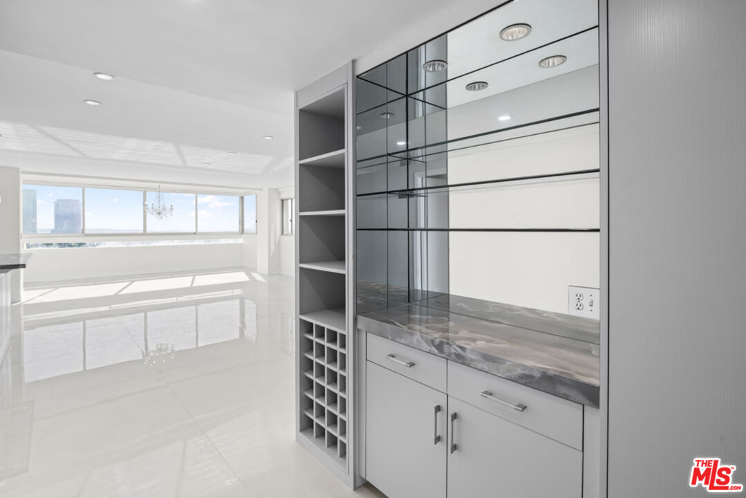 865 Comstock Avenue, Unit 10D/E Los Angeles, CA 90024 - Photo 17 of 49 a kitchen with granite countertop cabinets and window