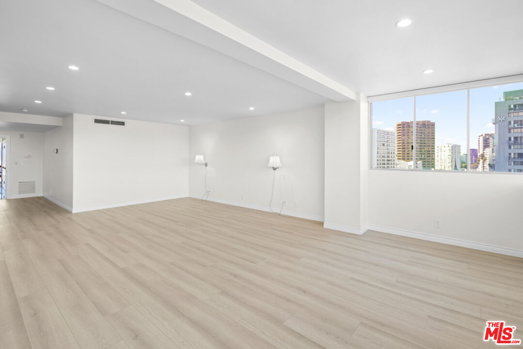 865 Comstock Avenue, Unit 10D/E Los Angeles, CA 90024 - Photo 21 of 49 a view of an empty room with wooden floor and a window