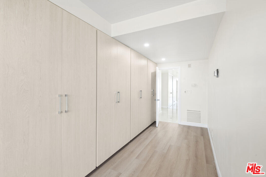 865 Comstock Avenue, Unit 10D/E Los Angeles, CA 90024 - Photo 24 of 49 a view of a hallway with wooden floor