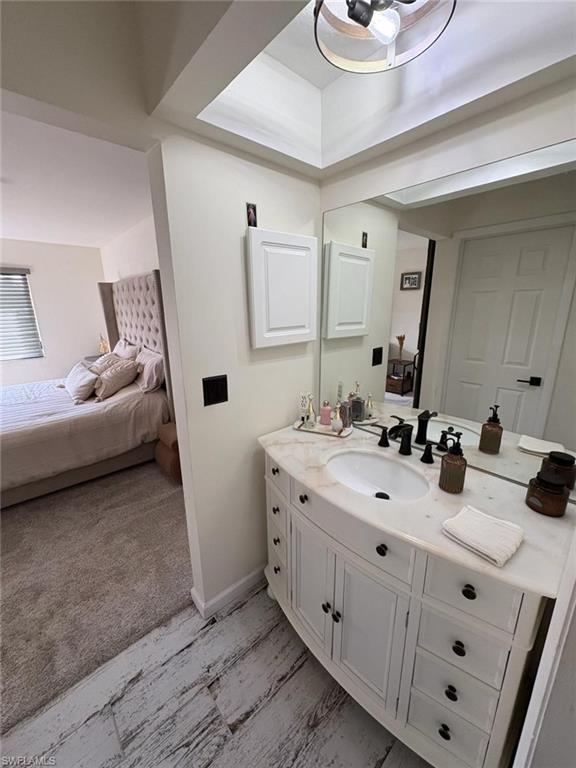 4120 Looking Glass Lane, Unit 3708 Naples, FL 34112 - Photo 18 of 25 Bathroom featuring connected bathroom, vanity, and light colored carpet