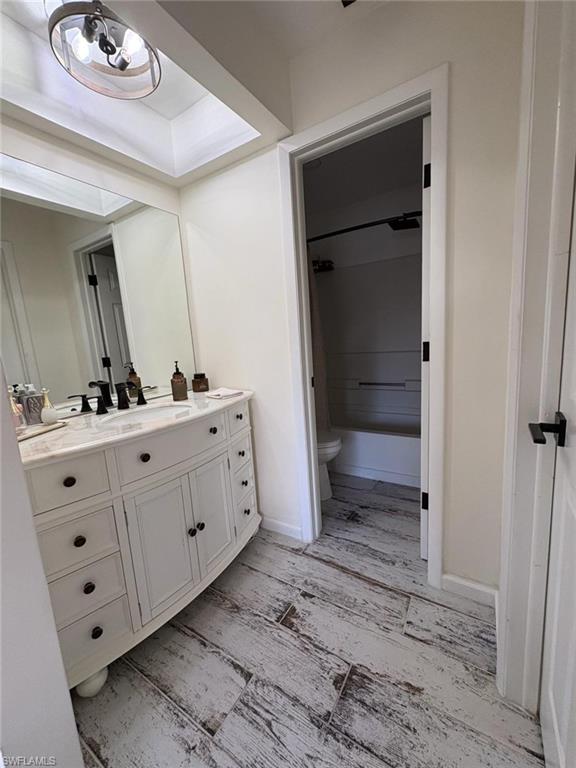 4120 Looking Glass Lane, Unit 3708 Naples, FL 34112 - Photo 19 of 25 Bathroom with vanity, light wood-style floors, and shower / bath combination