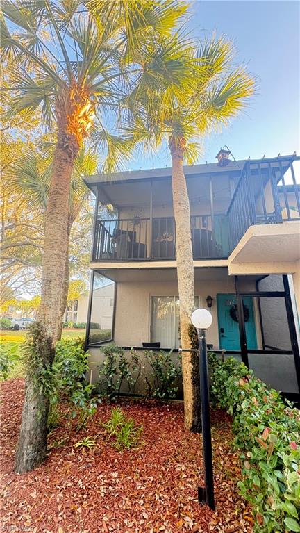 4120 Looking Glass Lane, Unit 3708 Naples, FL 34112 - Photo 2 of 25 Front of condo featuring stucco siding and a balcony
