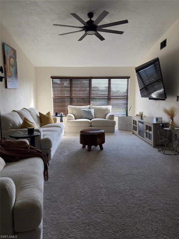 4120 Looking Glass Lane, Unit 3708 Naples, FL 34112 - Photo 5 of 25 Living area featuring light carpet and a ceiling fan