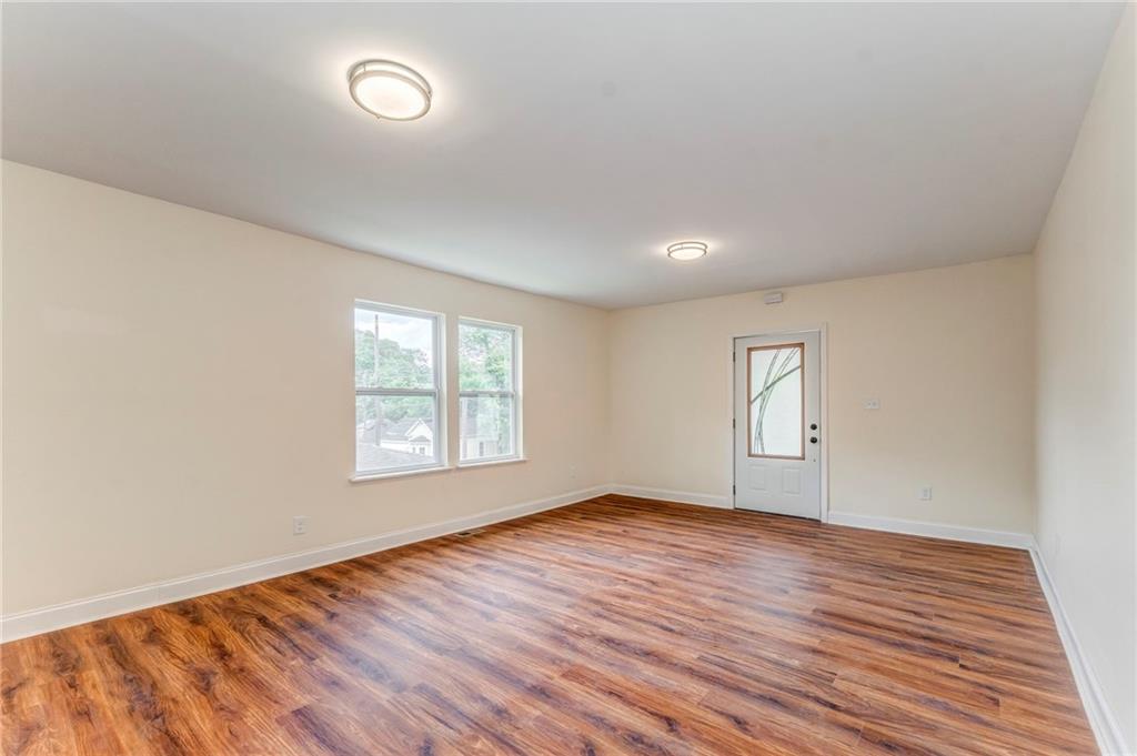 310 Kingston Avenue Northeast Rome, GA 30161 - Photo 17 of 45 an empty room with wooden floor and windows